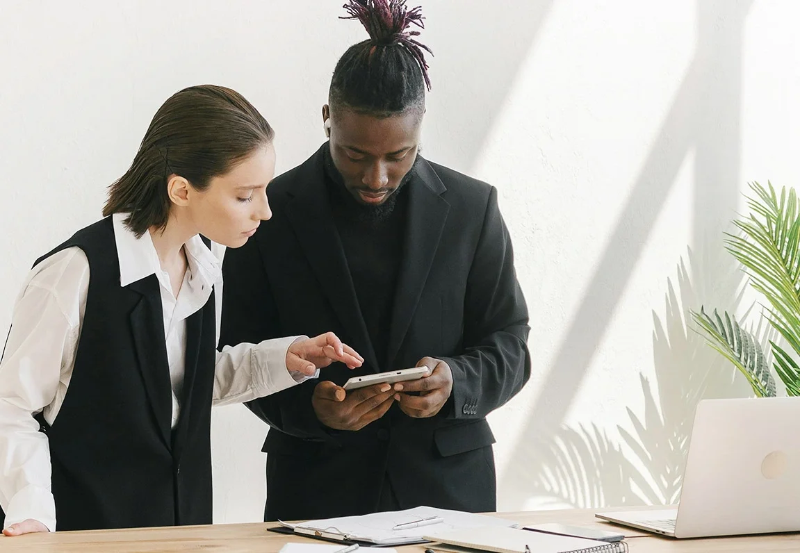 Two colleagues reviewing strategy plans together