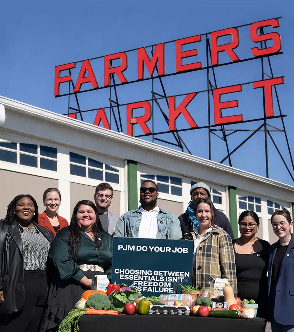 Staropoli team at the farmers market with a community food-access display